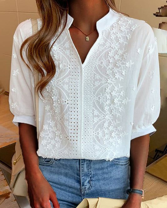 Blusa a tinta unita con maniche corte e scollo a V