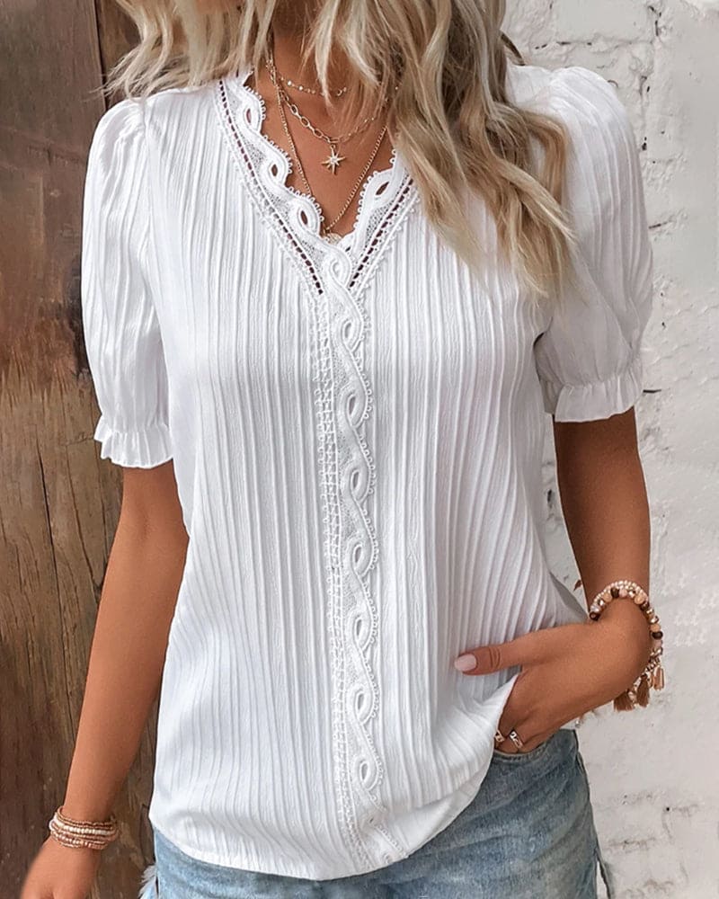 Elegante blusa da donna con pizzo e scollo a V